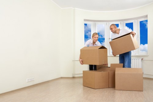 Loading household items into a van for a move in Acton