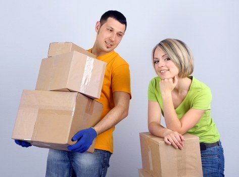 Packed household boxes and furniture ready for man and van transport