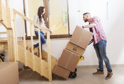 Professional moving van loading household items in Acton